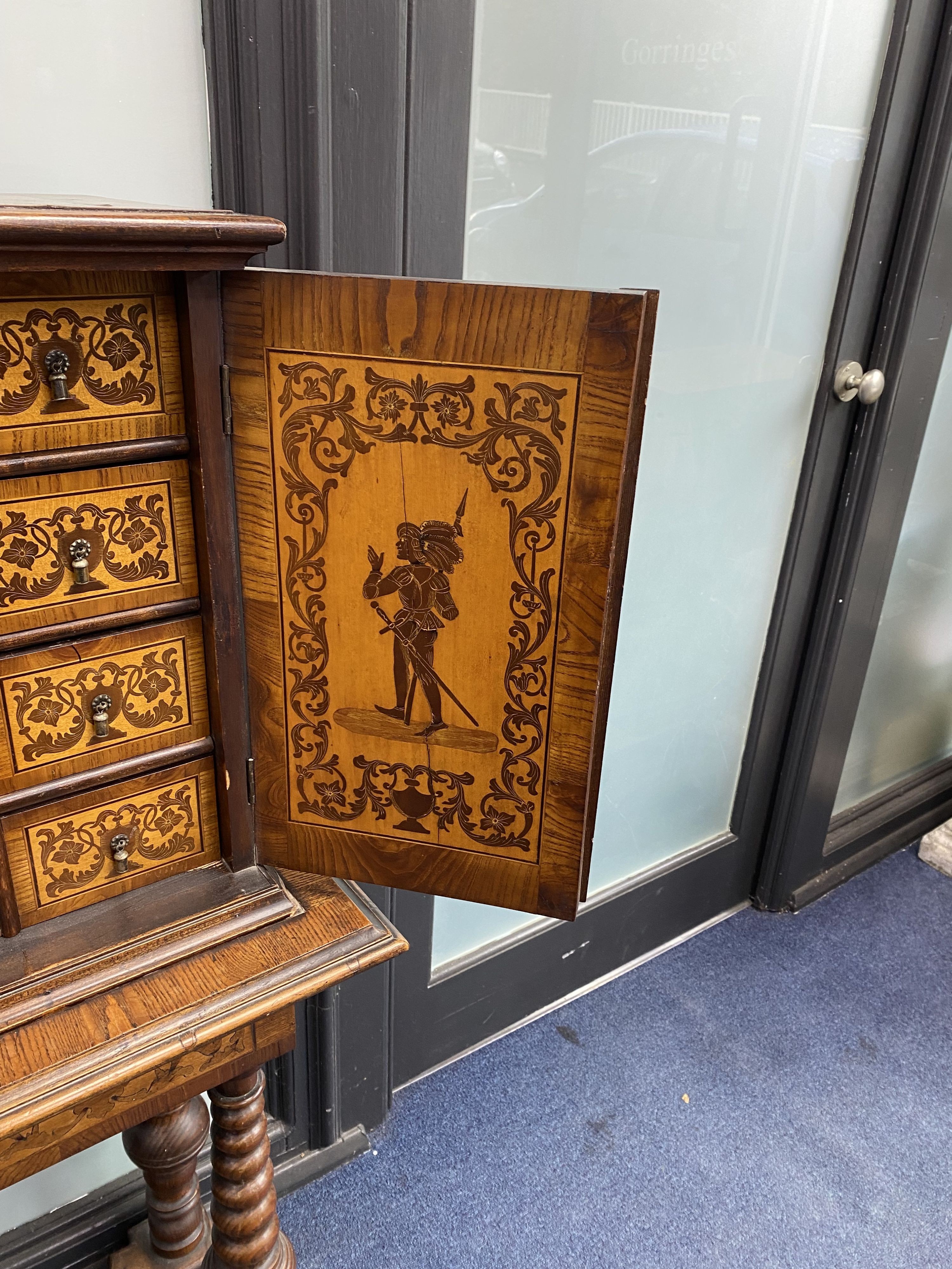 A Continental marquetry cabinet on stand, width 65cm, depth 36cm, height 126cm